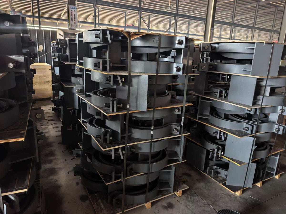 Pipe shoes and saddle supports stacked on pallets in factory warehouse